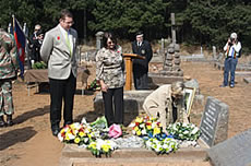 Evan Davies' granddaughter Colleen de Klerk laying a wreath on her grand father's grave attended by granddaughter Gilda Biassoni and great grandson Pierre de Klerk